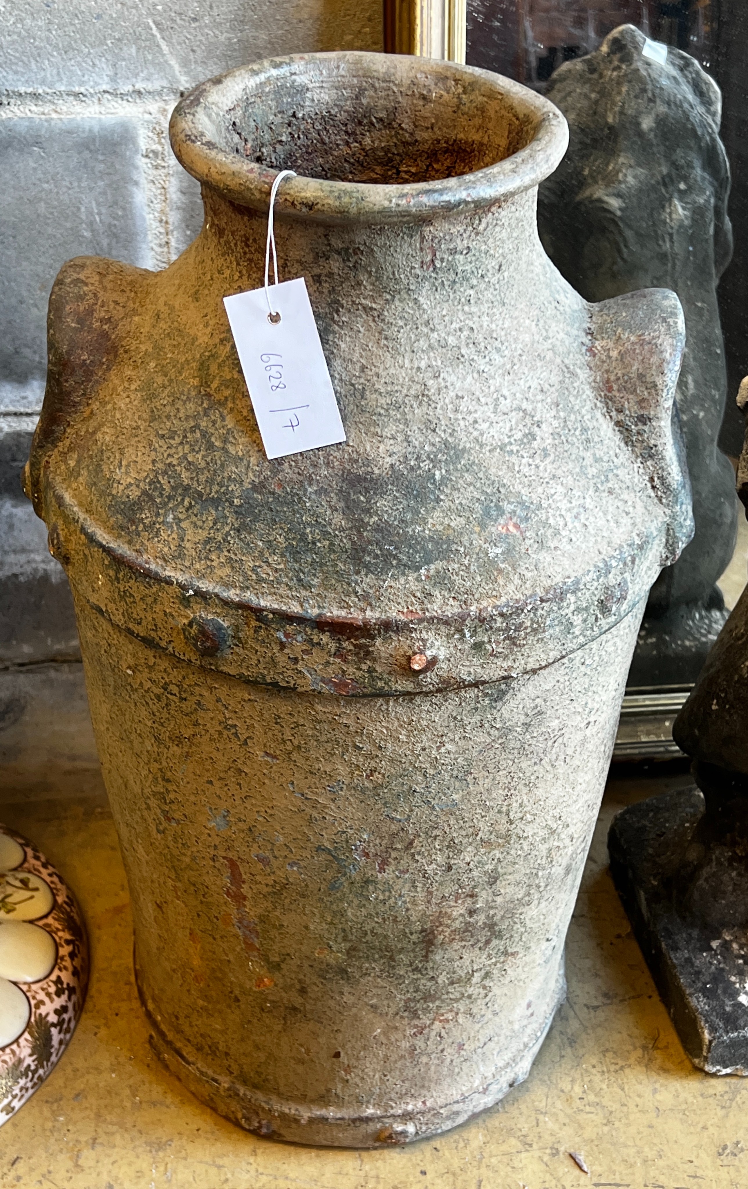 A glazed earthenware faux cast iron urn modelled as a milk churn, height 56cm